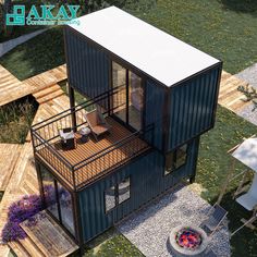 an aerial view of a small house made out of shipping containers and steel pipes with a deck