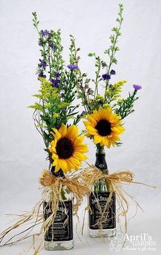 three vases with sunflowers in them are tied to burlap twine