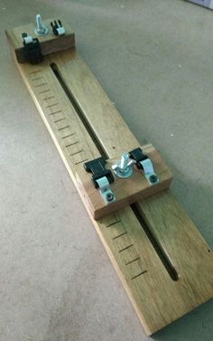 a pair of wooden rulers sitting on top of each other in the middle of a floor