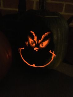 a pumpkin carved to look like a cat