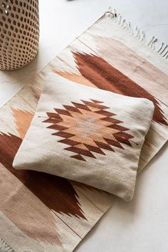 two pillows sitting on top of a white table