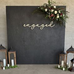 a sign that says engaged next to some candles