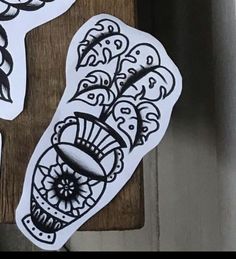 some stickers that are on top of a wooden table and one is black and white