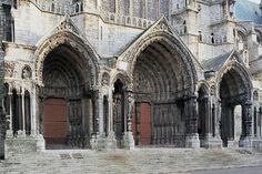 an old cathedral with stone steps and arches