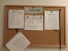 a bulletin board with papers attached to it and some clippings on the wall