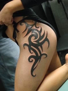 a woman with a tattoo on her thigh