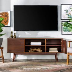 an entertainment center with a flat screen tv mounted on the wall