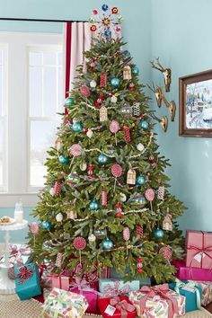 a decorated christmas tree with presents under it