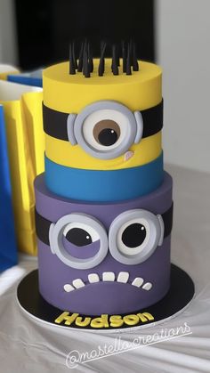 a three tiered cake made to look like a minion