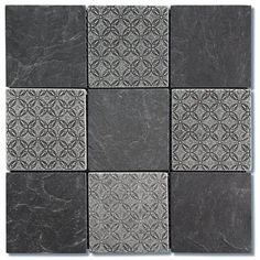 black and white tile with an intricate design on the back side, set against a gray background