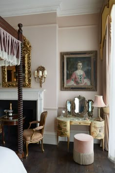 a bedroom with pink walls and antique furniture