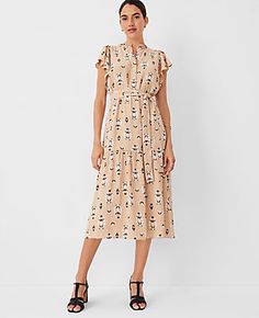 Step into the season with the Ann Taylor Floral Flutter Sleeve Midi Flare Dress, a perfect blend of elegance and comfort. This dress features a charming baguette color adorned with vibrant floral prints that capture the essence of summer.

- Size: XS (Regular fit)
- Color: Baguette
- Material: 100% Polyester
- Gender: Female
- Design Details: Ruffle split neck, flutter sleeves with shirred caps, elasticized self-tie waist
- Length: 30 inches from natural waist
- Hem: Peplum style
- Care: Machine Shirred Sleeve, Midi Flare Dress, Getaway Dress, Female Design, Peplum Styles, Peplum Hem, Sleeve Midi Dress, Midi Dress With Sleeves, Midi Maxi Dress