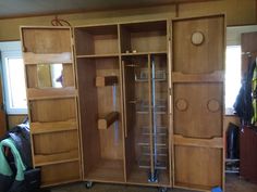 an open wooden cabinet in a room