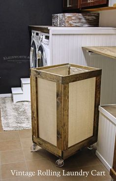 a tall wooden box sitting on top of a floor next to a white chair and rug