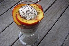 a dessert in a glass on top of a wooden table