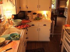 a kitchen filled with lots of food on top of a counter