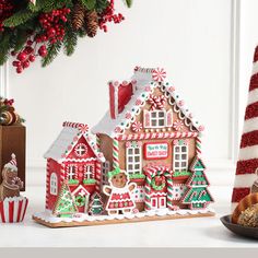 a gingerbread house is decorated with candy canes and christmas decorations for the holiday season