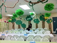 a room filled with tables and chairs covered in green decorations