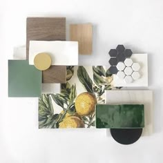 an arrangement of different shapes and colors on a white surface with wood, tile, and acrylic paint