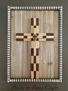 a cross made out of wood and bead trims on a wall with the words pieces to place crafts written below it