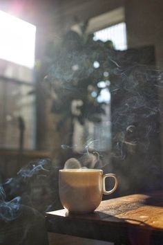 a coffee cup sitting on top of a wooden table