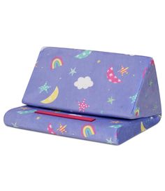 a purple case with rainbows, stars and clouds printed on it is sitting next to a red pen