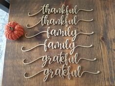 a wooden sign that says thank you, thanksgiving family and grateful gratefully written in cursive writing