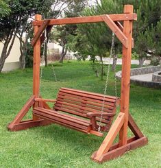 a wooden swing set in the grass