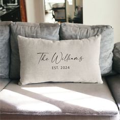 a couch with a pillow that says the williams est 2012