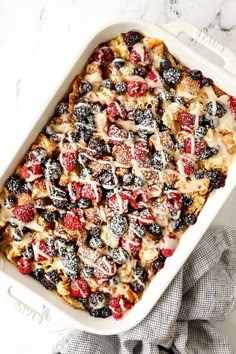 a casserole dish filled with berries and cream