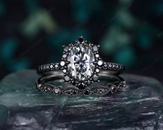 a diamond engagement ring on top of a rock