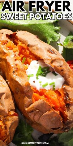 baked sweet potatoes with sour cream on top and lettuce in the middle, sitting on a white plate