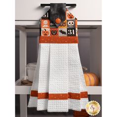 a kitchen towel hanging on a rack with halloween decorations