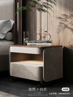 a nightstand with a bike on it next to a bed and a potted plant