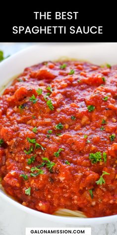 homemade spaghetti sauce in a white bowl with parsley on top and text overlay