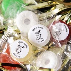 four different colored donuts wrapped in plastic wrappers with writing on the top and bottom