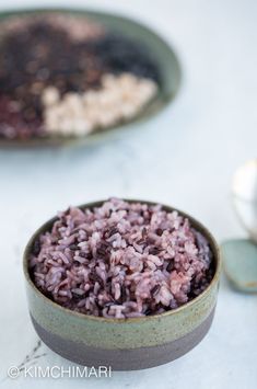 two bowls filled with rice on top of a table