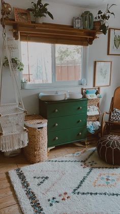 a baby's room with a green dresser and white rug on the floor in front of a window