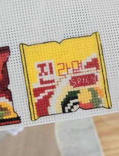 the cross stitch pattern has been made to look like a bag of chips and a packet of chips