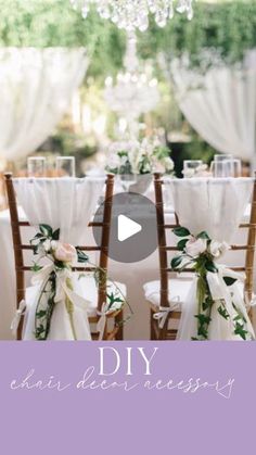 two chairs with bows and flowers on them are set up in front of a chandelier