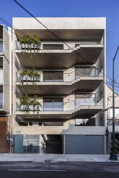 an apartment building with balconies on the second floor