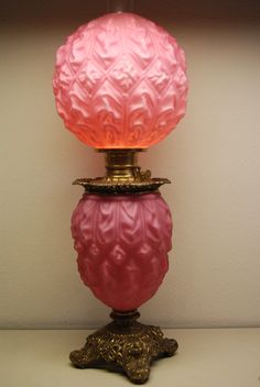 a pink lamp sitting on top of a table