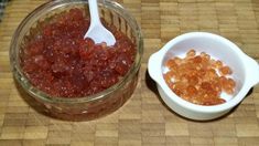 two bowls filled with different kinds of gummy bears