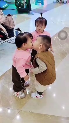 three small children standing next to each other