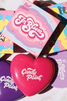 the candy hearts are all different colors and shapes, with one heart shaped box on top