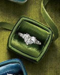 an engagement ring in a green velvet box