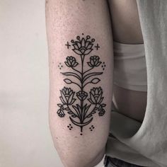 a black and white flower tattoo on the arm