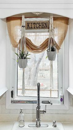 the kitchen window is decorated with hanging plants