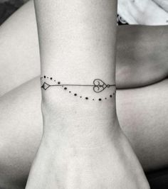 a woman's wrist tattoo with an arrow and stars on the bottom of her arm