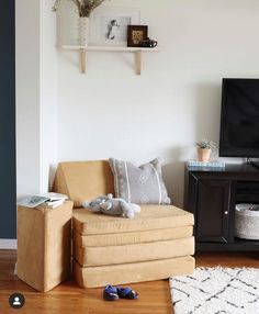 a living room with a couch, chair and television